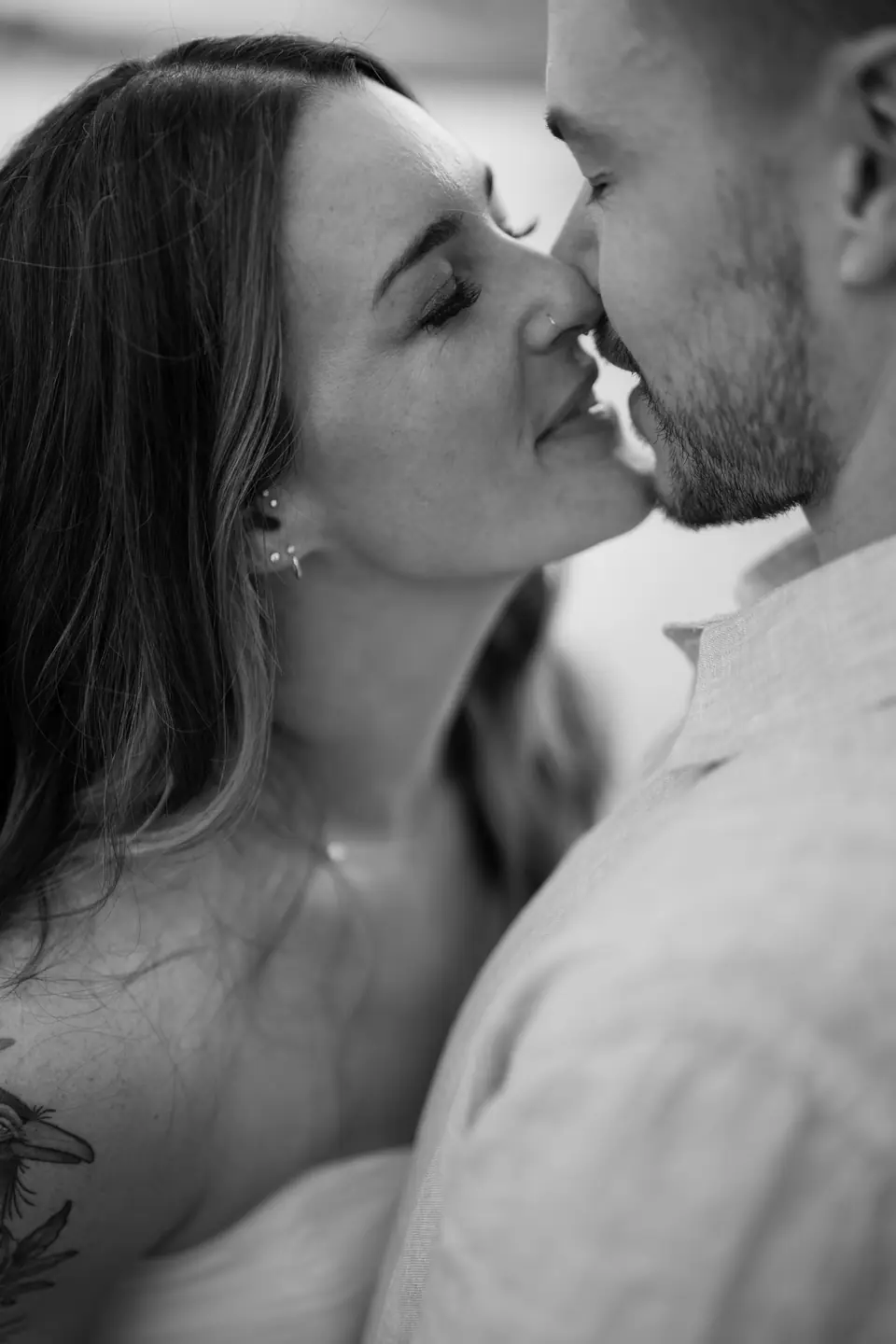 Black and white close-up of the couple about to kiss.