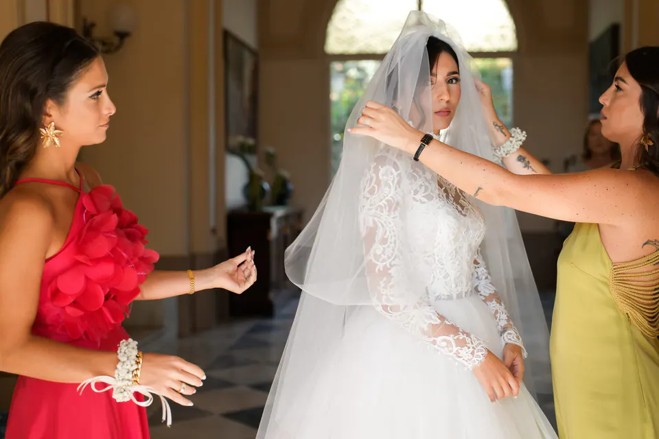 Mother of the bride fixing her veil before the ceremony.