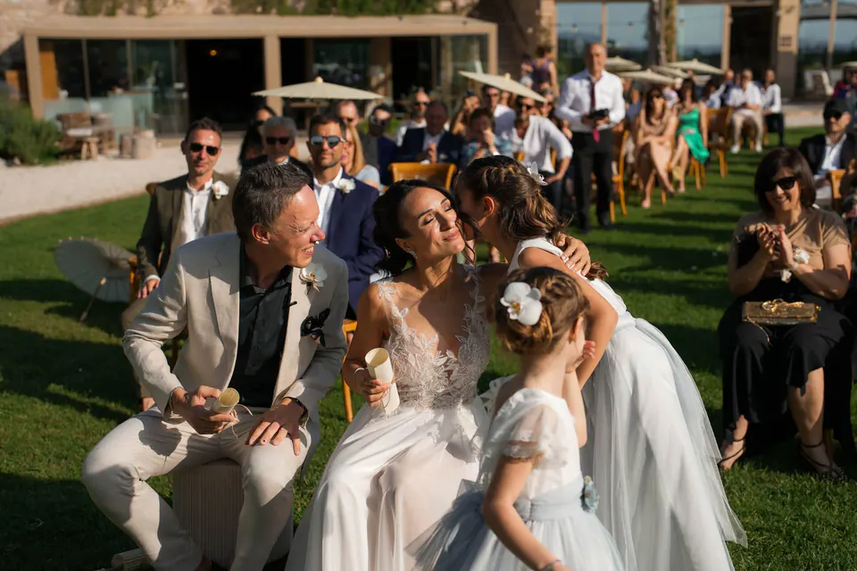 Bride greeting guests and children on the lawn