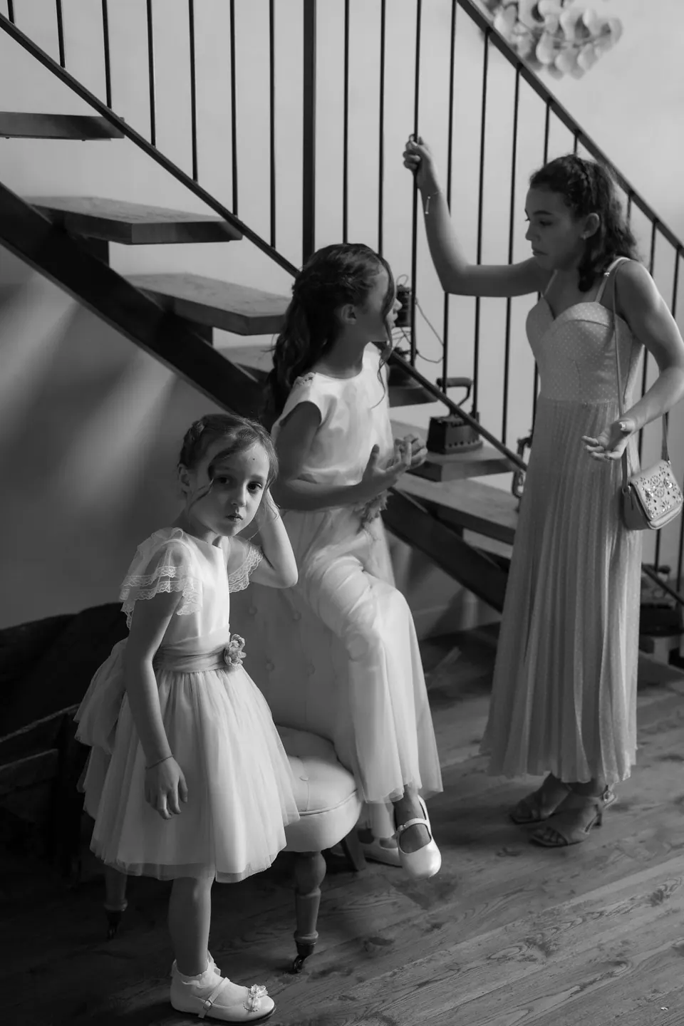 Black and white photo of the flower girls on the stairs