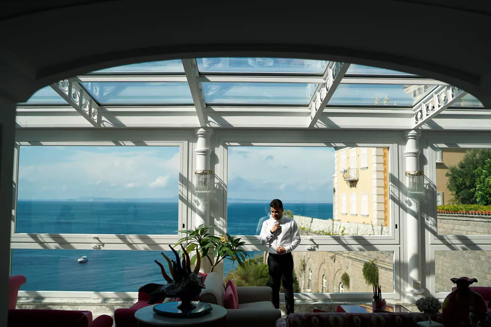 The glass-roofed room of Hotel Corallo looking out to the sea.