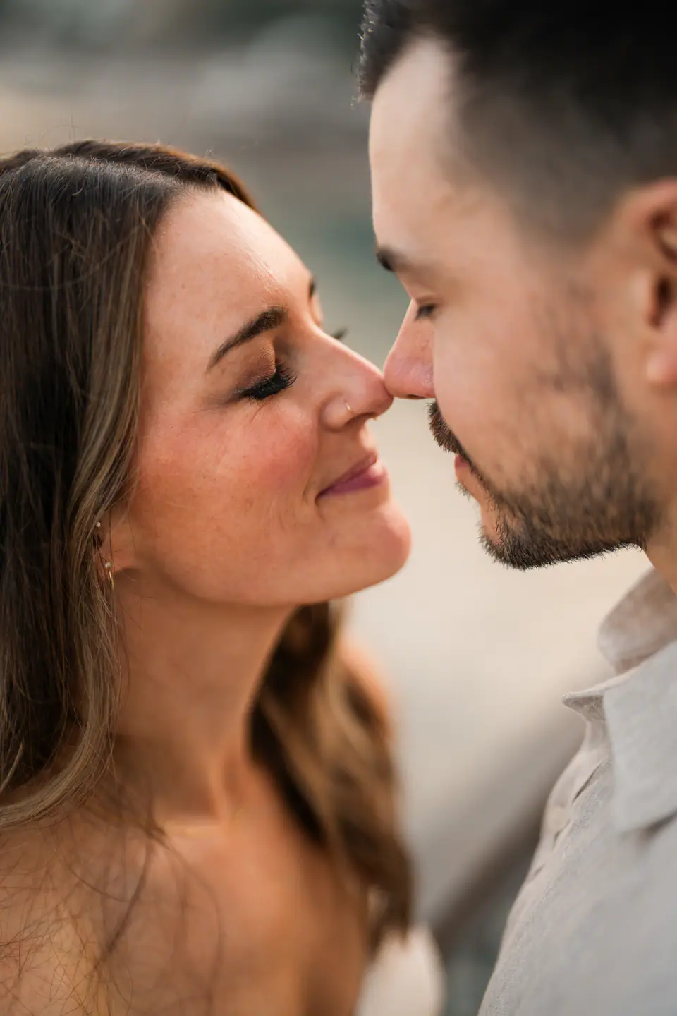 Close portrait of the couple nose to nose, eyes closed.