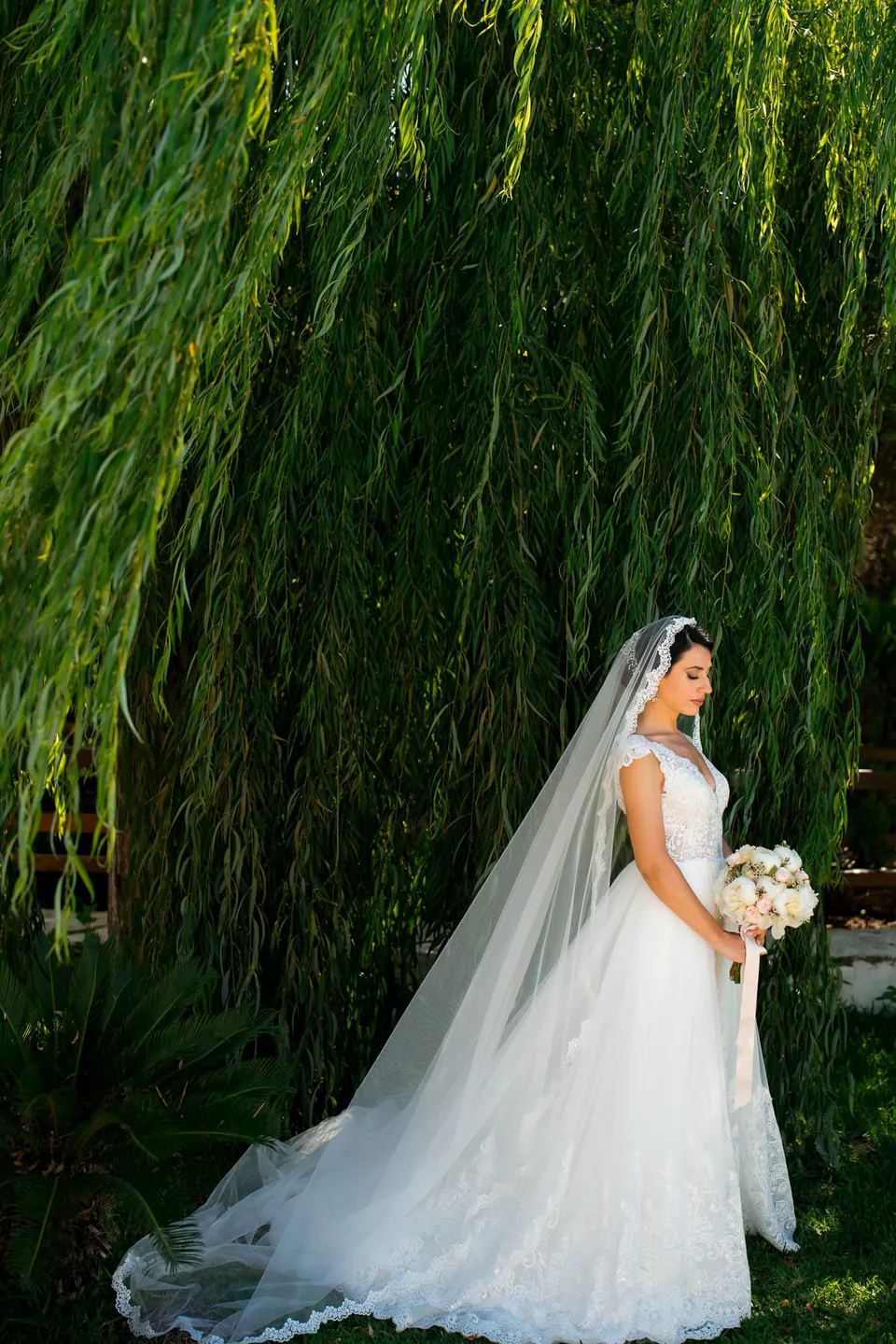 Bride surrounded by lush greenery, editorial wedding photography Sicily.