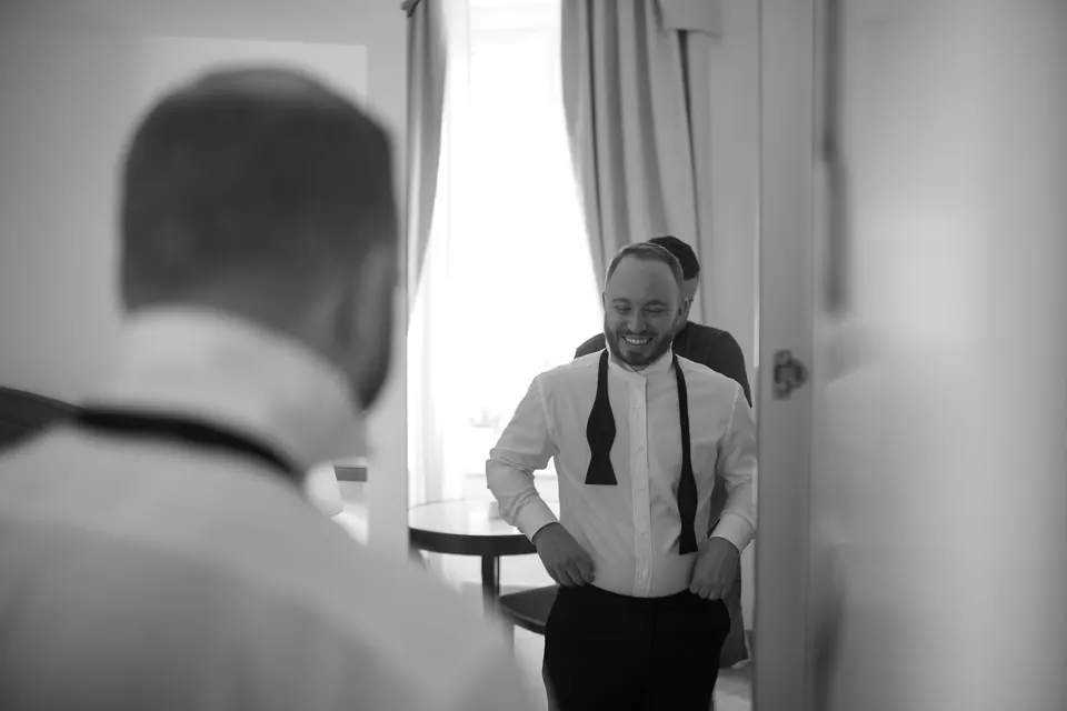 Groom getting dressed in his suite at Belmond Hotel Caruso.