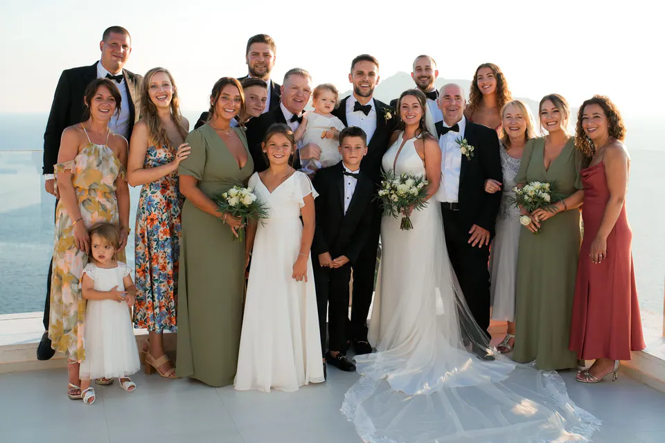 Group portrait of the bride, groom, and guests celebrating together after the ceremony.