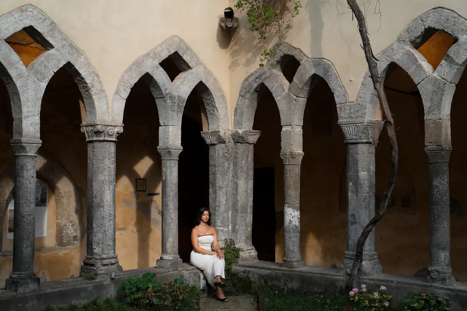 Sitting alone under the arches of a cloister.