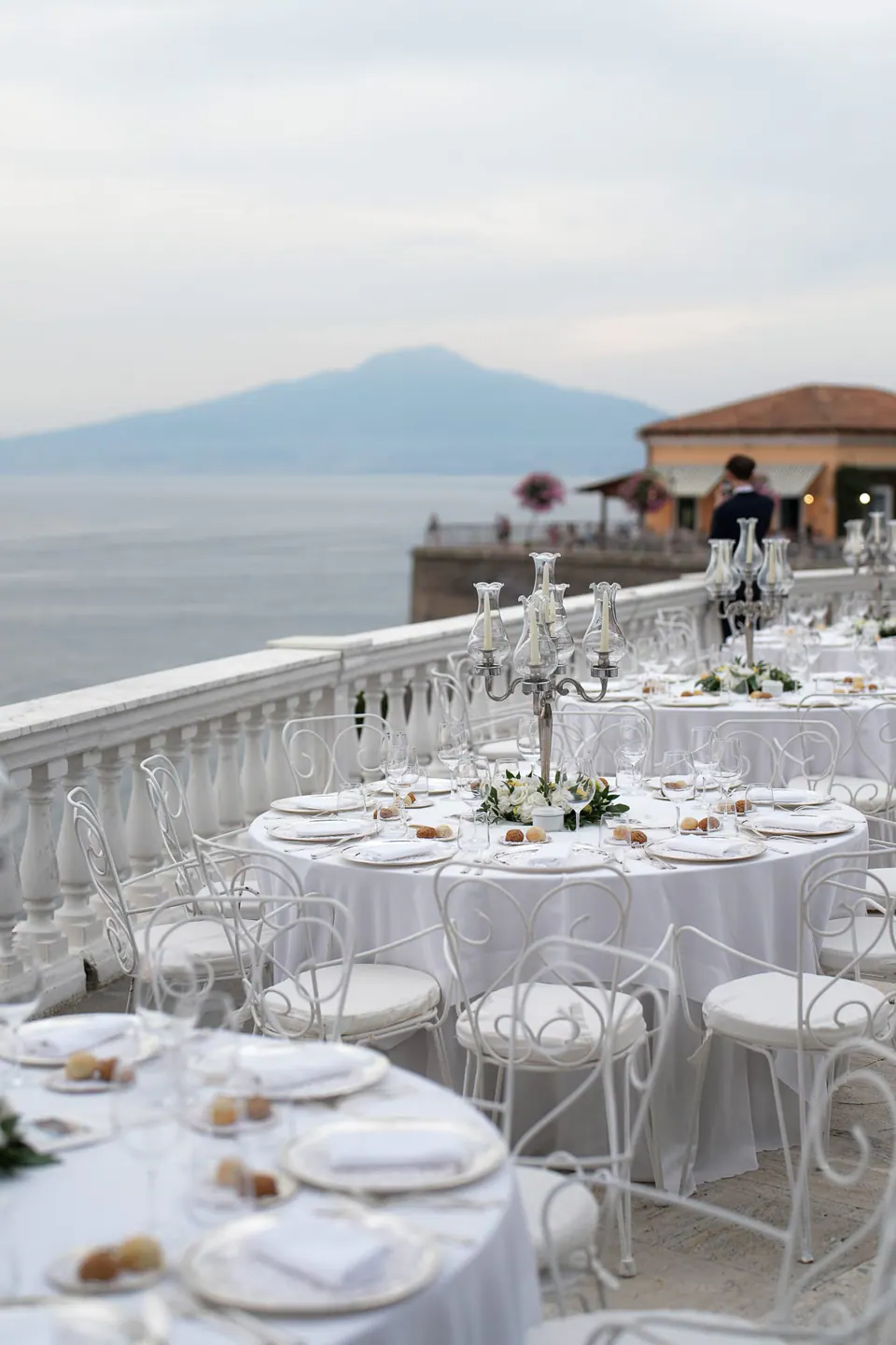 Reception tables on the terrace of Grand Hotel La Cocumella, overlooking the sea.